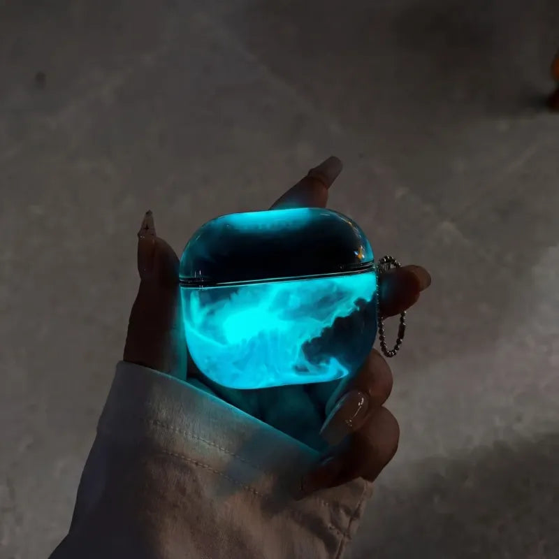 Hand holding a glowing electric blue case against a dark background