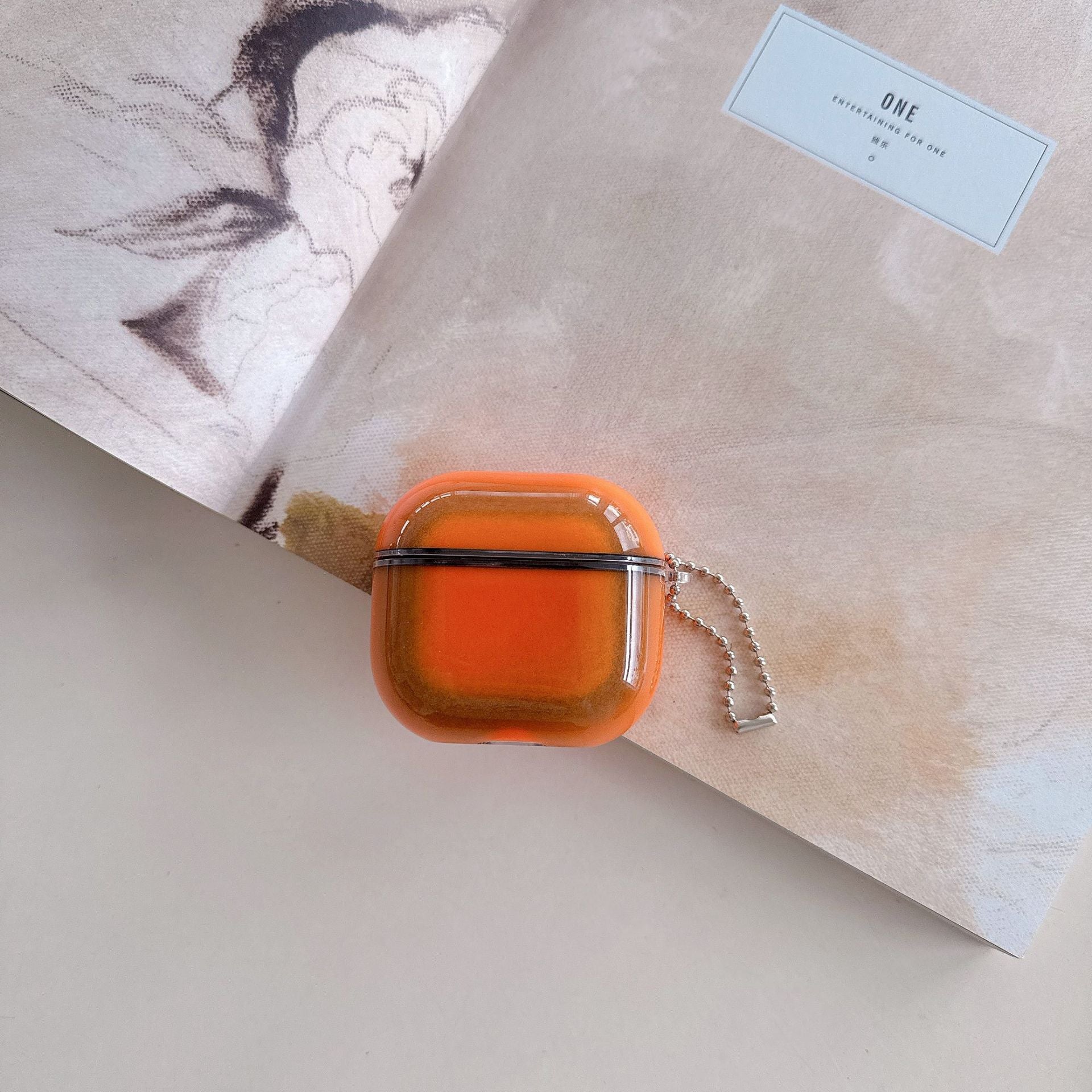Molten Orange square hair clip on a textured surface with a blurred background